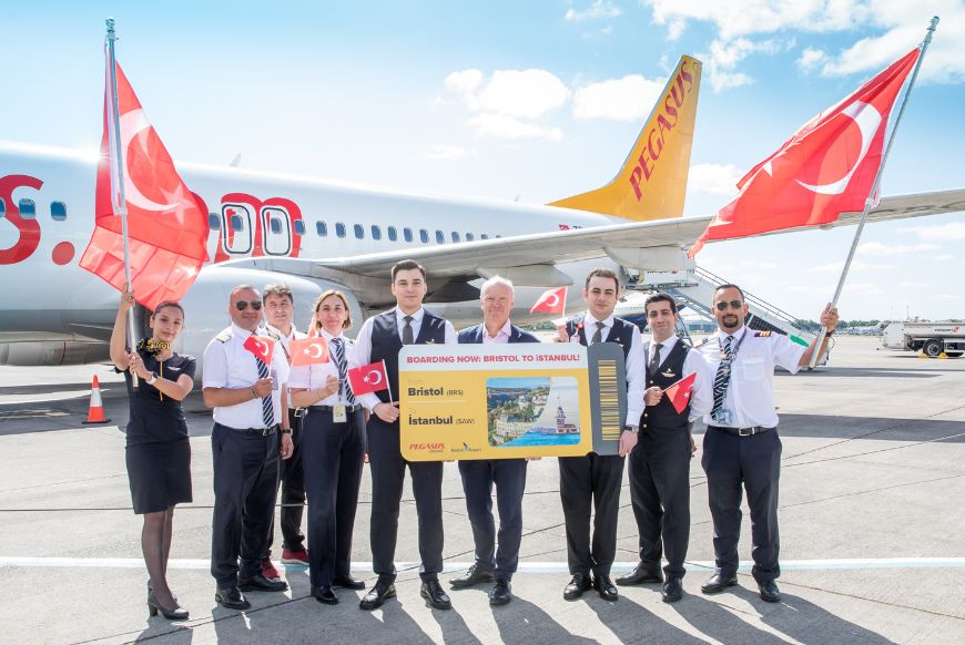 airplane crew standing in front of airplane with turkey flags